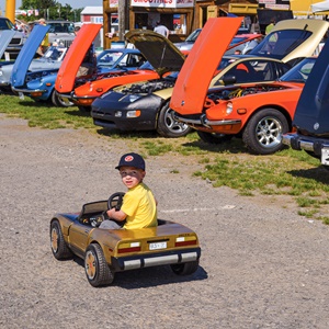 Child driving a toy Z car.